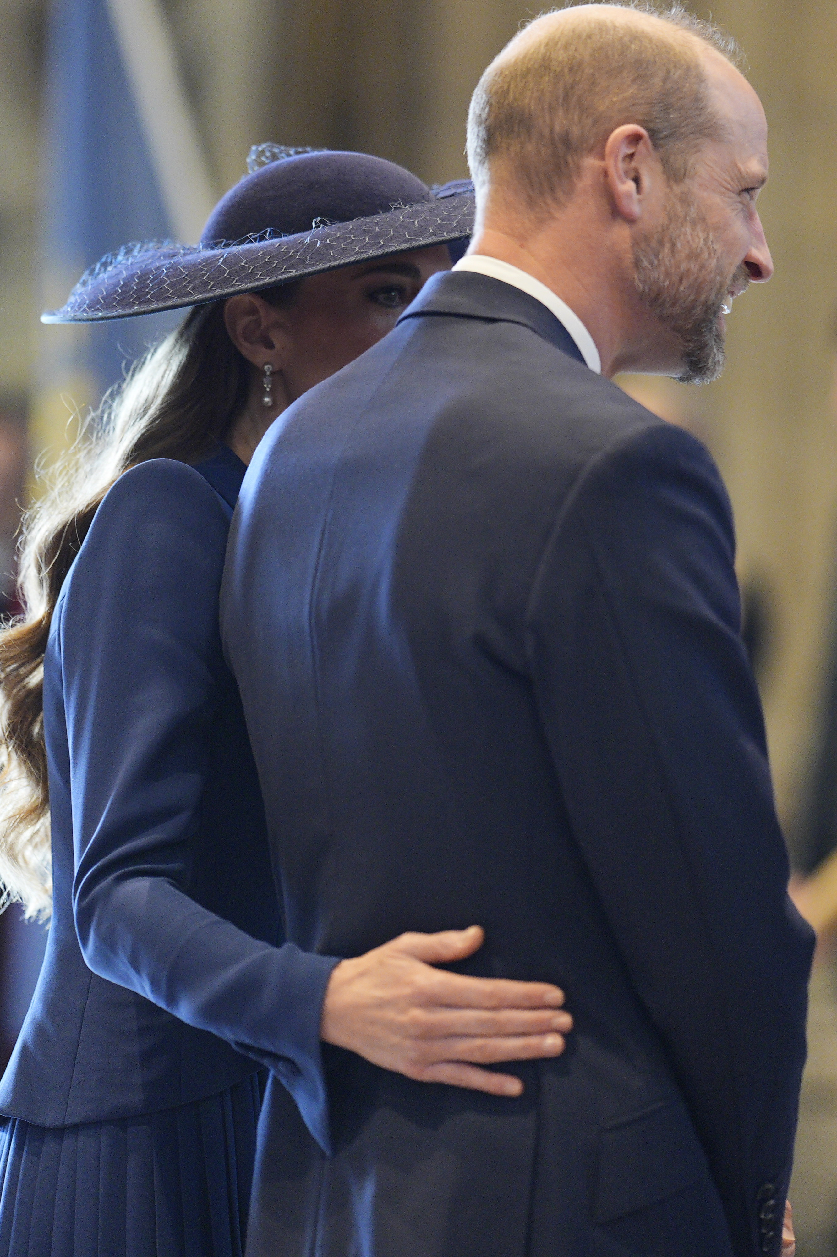 Princess Kate putting her arm around Prince William