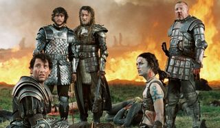 King Arthur Clive Owen and Keira Knightley, with their fellow warriors, sit in front of a burning fi