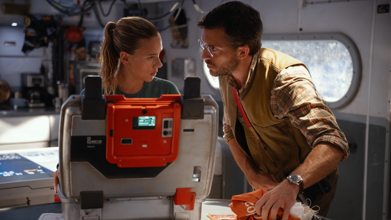 Scarlett Johansson looks at Jonathan Bailey with concern in Jurassic World Rebirth.
