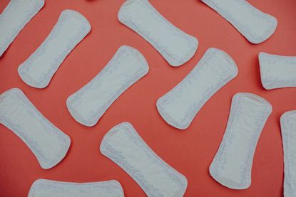 Heavy periods: Some sanitary pads on a red background