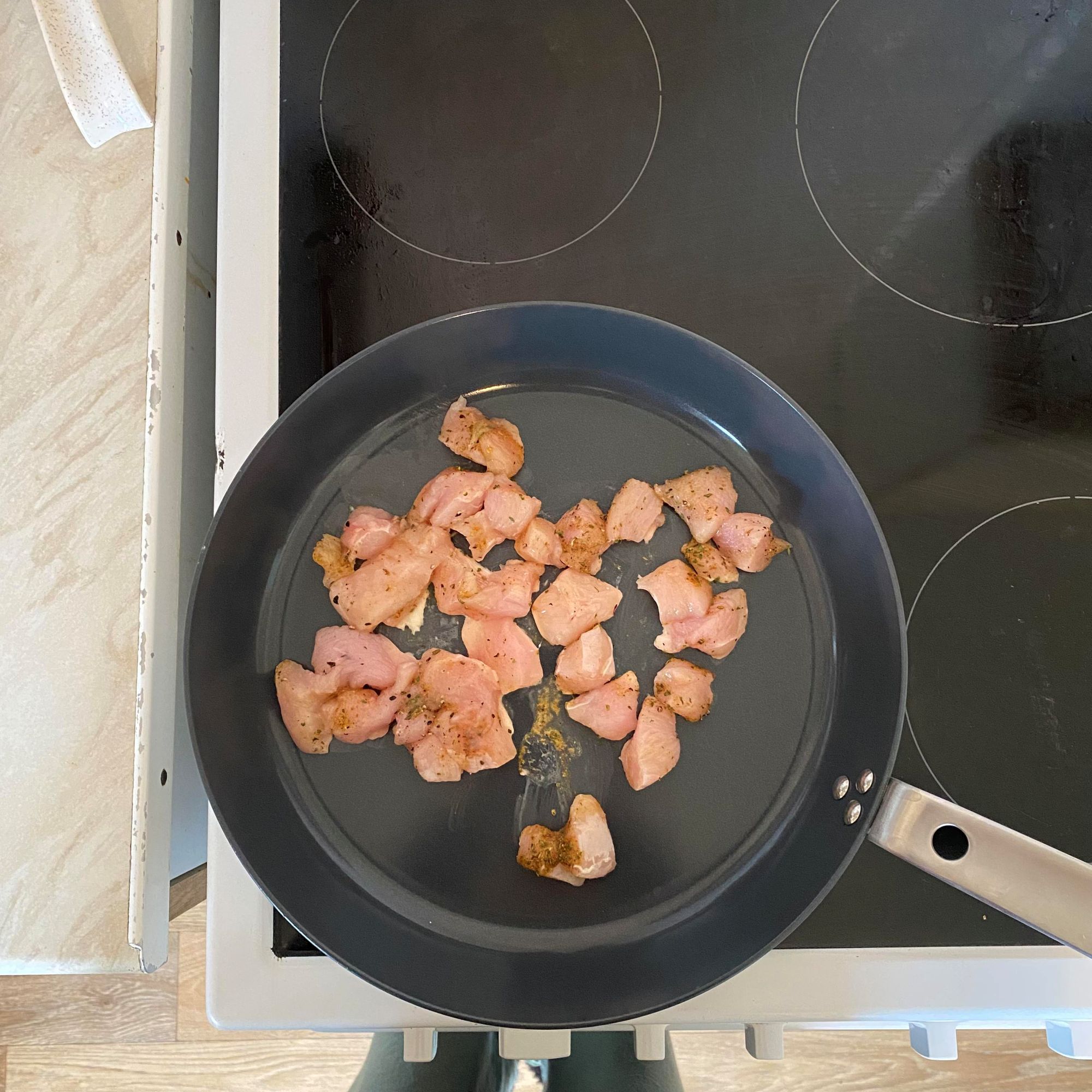chicken cooking in IKEA HEMKOMST frying pan