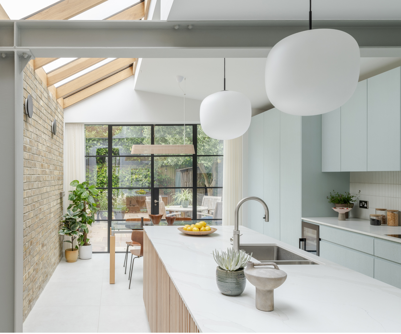 Kitchen with rooflights, island and patio doors overlooking the garden at the end
