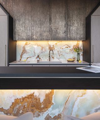 Dark kitchen with marble backsplash and LED lights