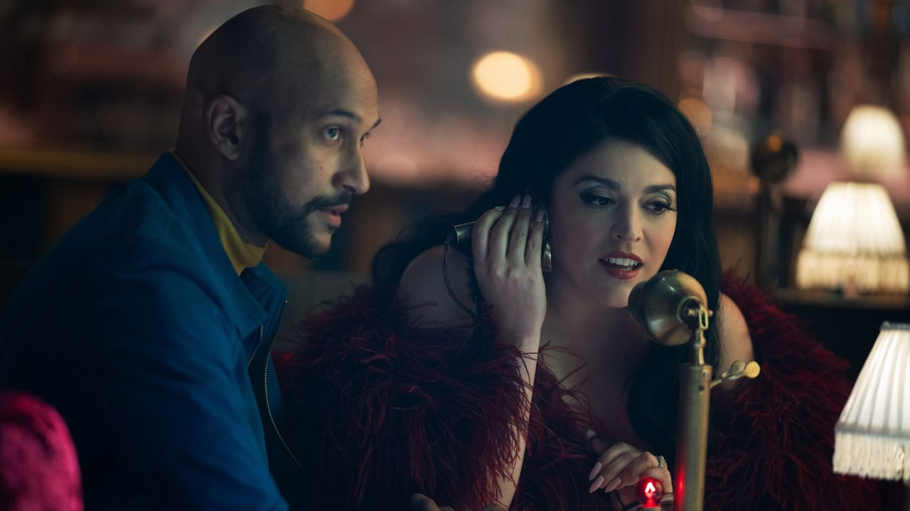 Keegan-Michael Key and Cecily Strong talk into a phone in Schmigadoon