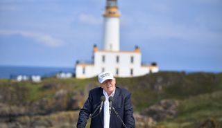 Trump talks in front of the lighthouse at Turnberry