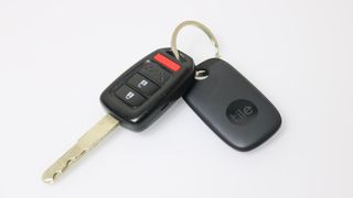 A car key with a Tile Pro bluetooth tracker on a keychain