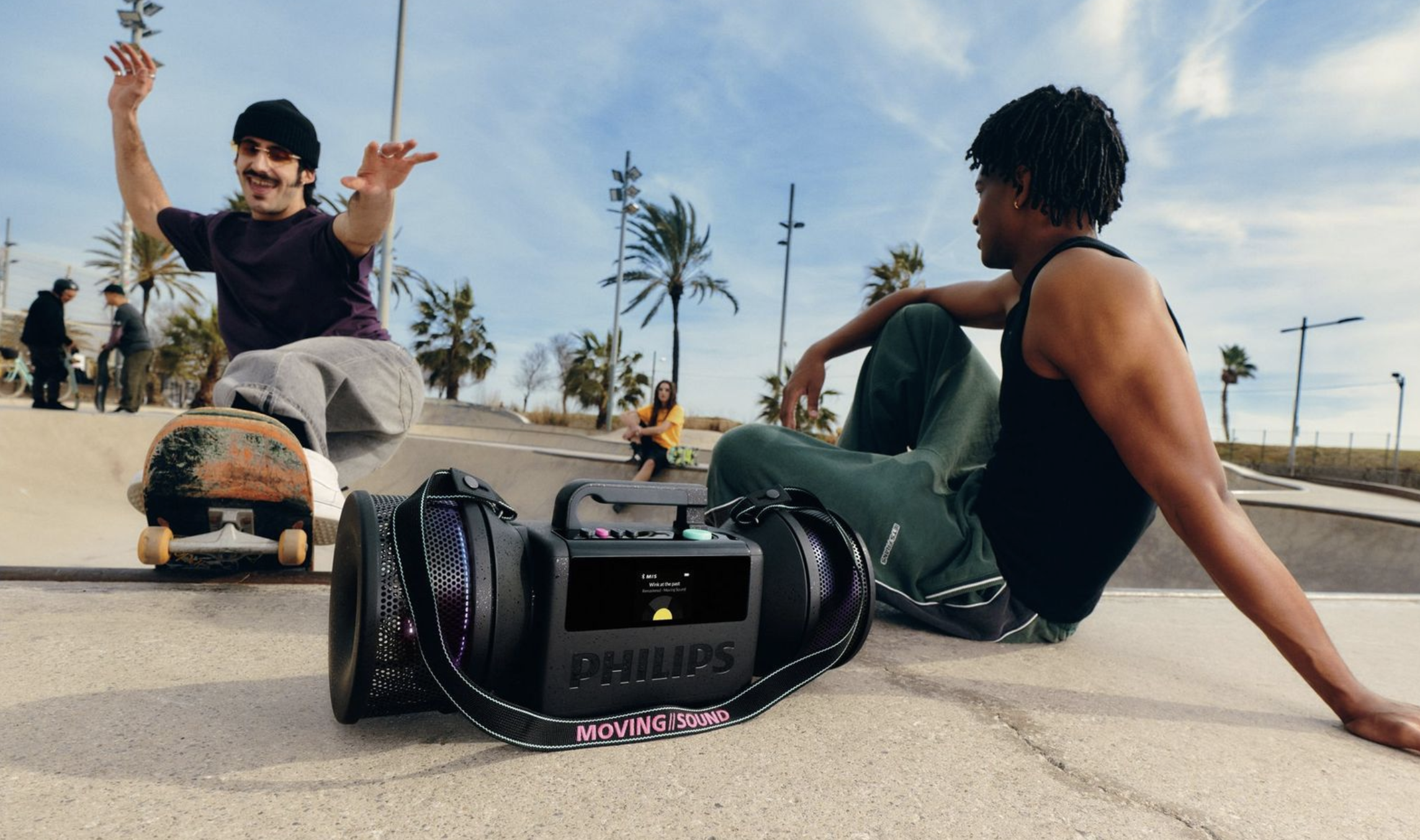 Philips audio products worn by a group of young people, with a skateboard