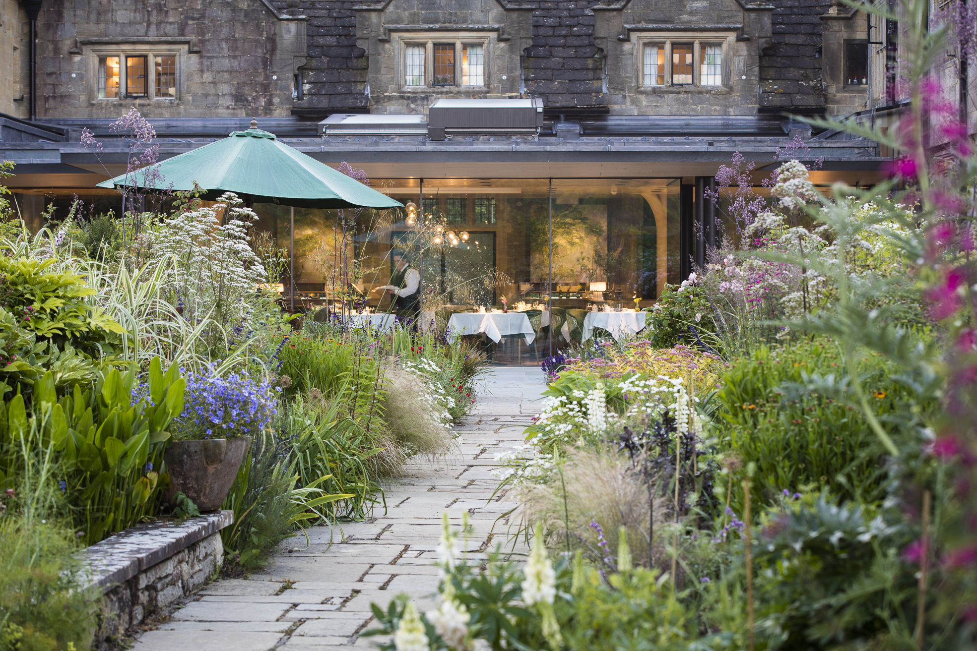 Gravetye Manor garden and glass fronted Michelin Star restaurant