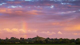 Landscape photo of Glastonbury tor with a rainbow and pink sky by Jeremy Walker