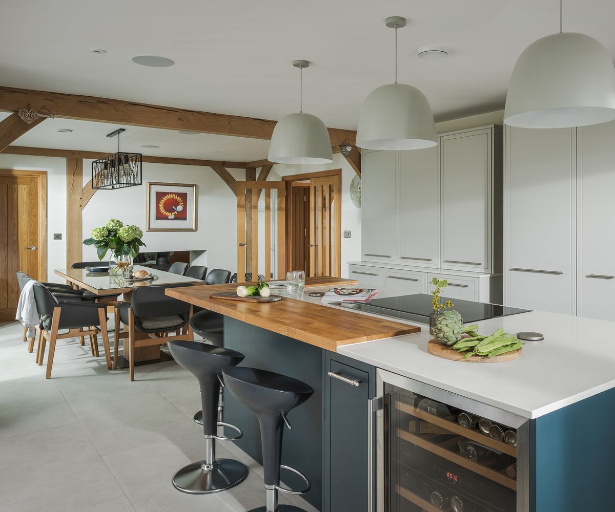 An open plan kitchen/diner in a self build home with exposed oak beams