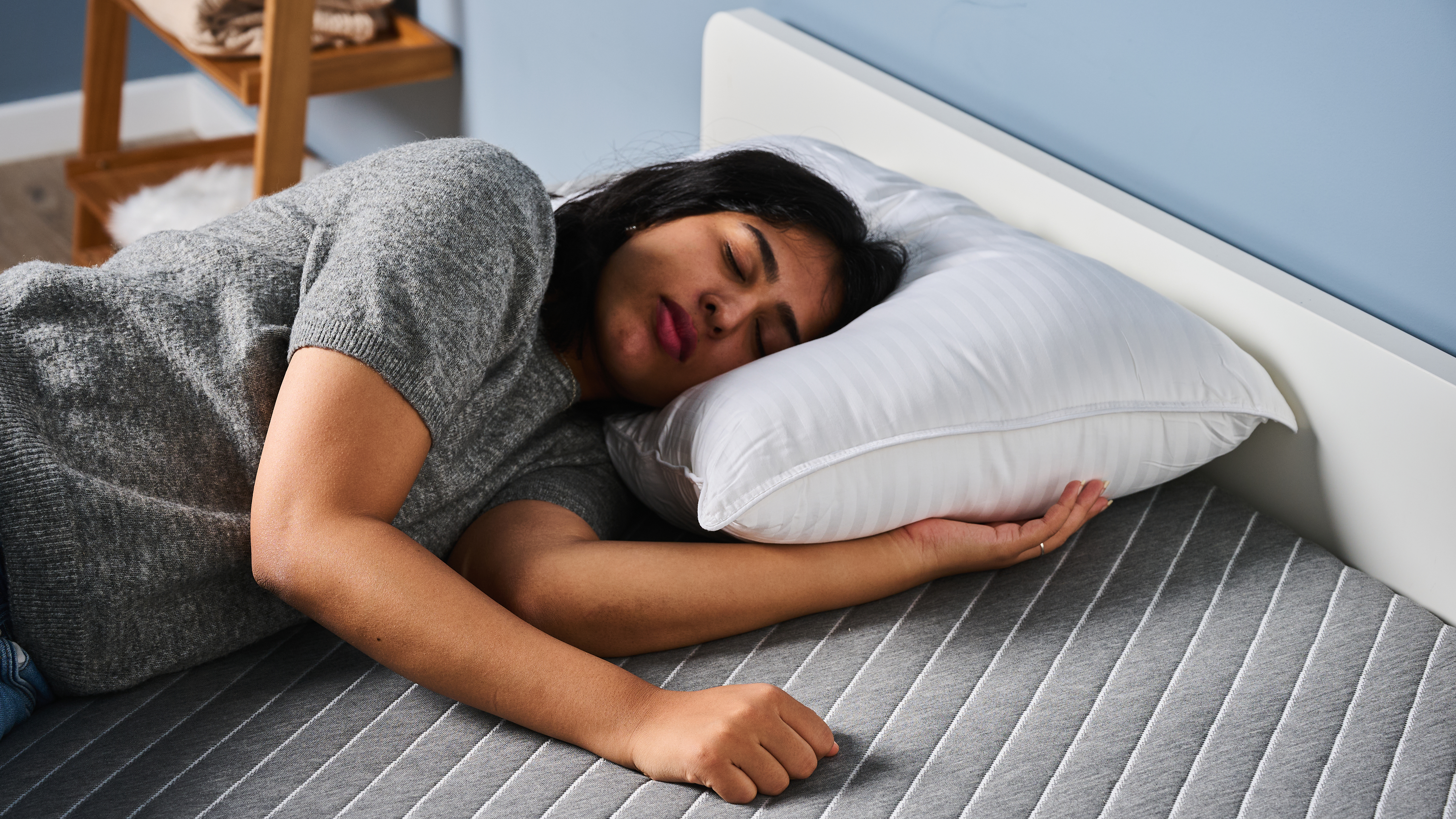 TG bedding writer testing the Beckham Hotel Collection Down-Alternative pillow by lying on it in our TG Sleep Studio