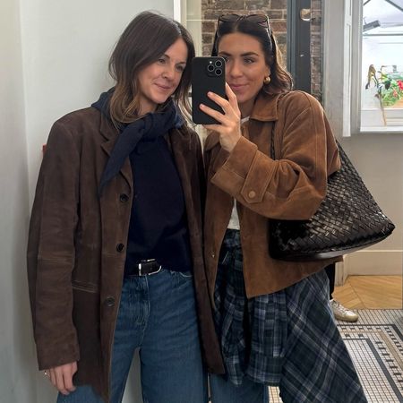 British style influencers Kim Turkington and Jessica Skye pose for a mirror selfie at Cafe Kitsune in London wearing chic 2026 outfit ideas with brown suede jackets and jeans