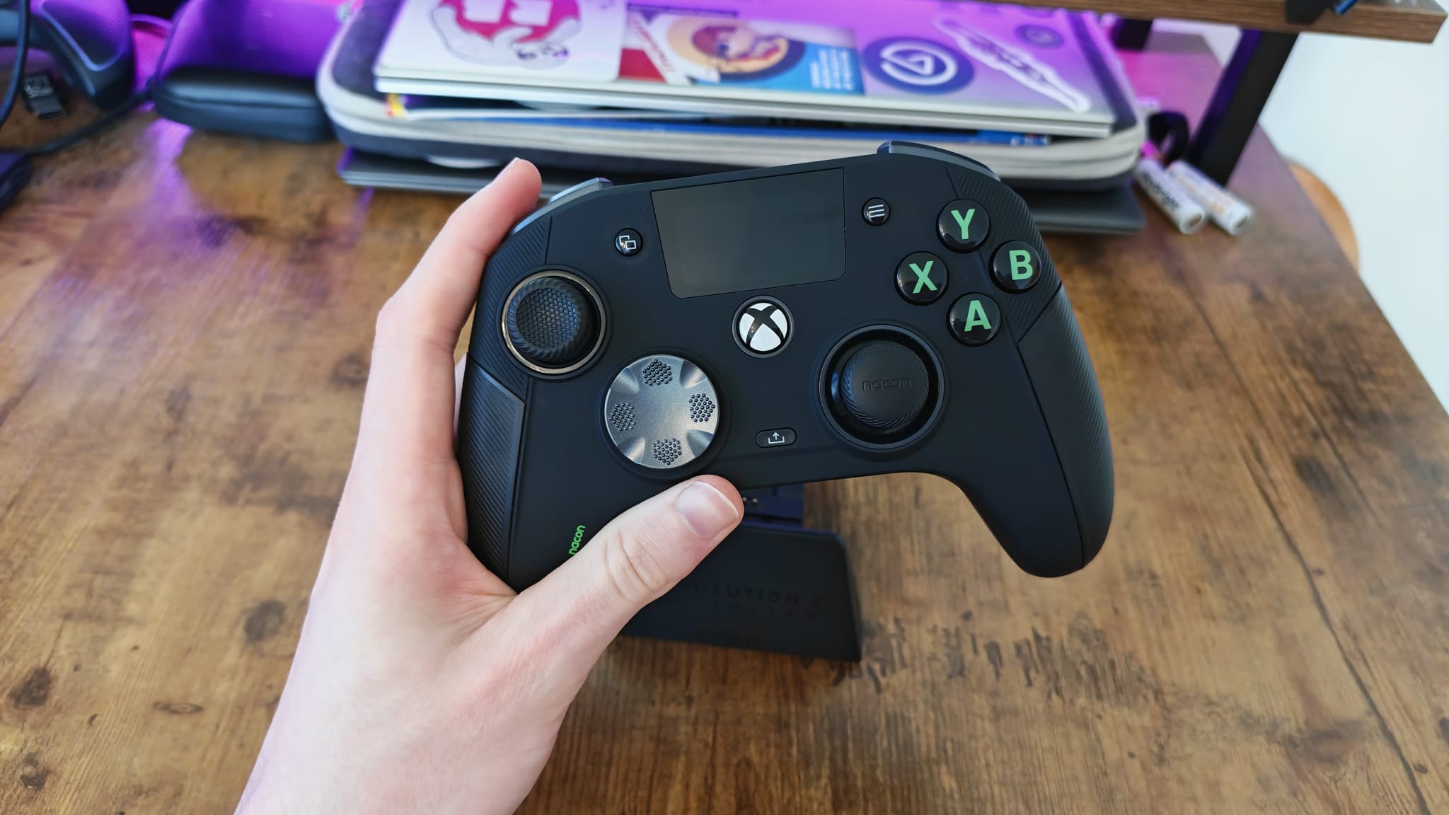 A reviewer holding the Nacon Revolution X Unlimited