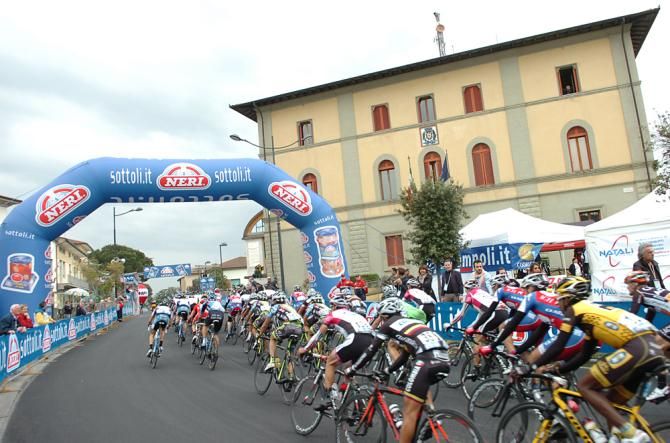 The peloton rolls through the start/finish