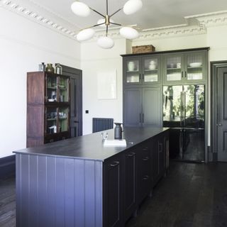kitchen with glass cabinet doors up high and large island