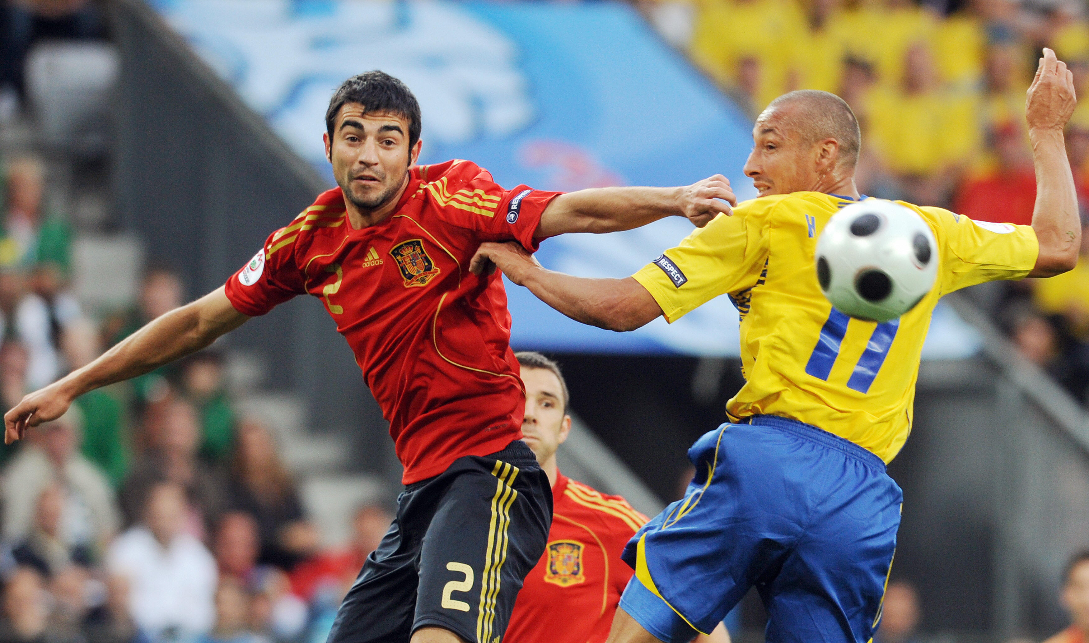 Spain's Raul Albiol competes for the ball with Sweden's Henrik Larsson at Euro 2008.