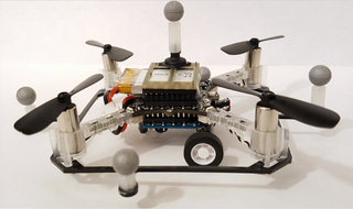 A quadcopter drone with wheels attached so it can fly and drive.