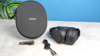 A pair of black Edifier WH950NB over-ear headphones photographed against a blue background