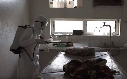 A health worker sprays down a hospital in Sierra Leone, during 2014's devastating Ebola outbreak