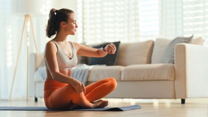 A woman doing a living room workout at home