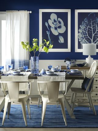 dining room with dark blue walls and coastal decor
