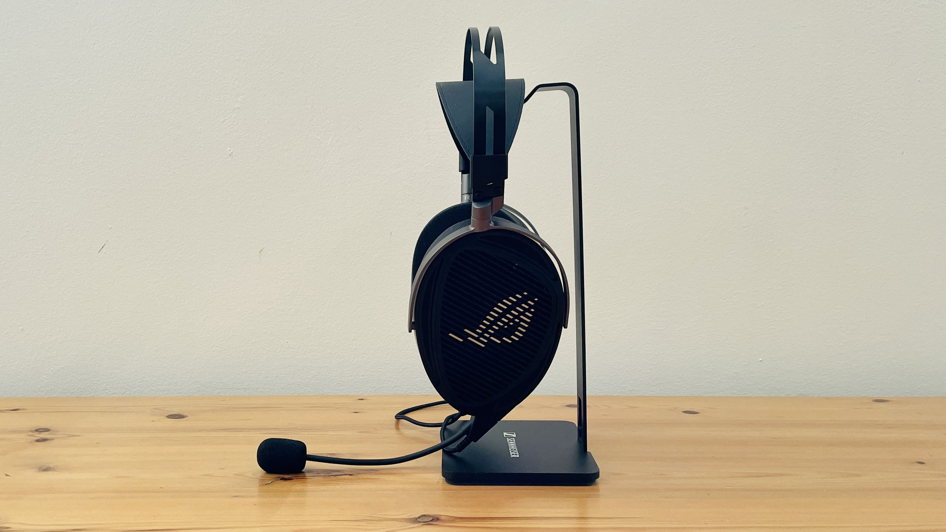 A picture of the Asus ROG Kithara audiophile wired gaming headset on a wooden surface.