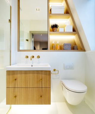 narrow bathroom ideas, with white walls, clever custom storage, brass fixtures and fittings