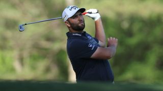 Jon Rahm plays a golf shot