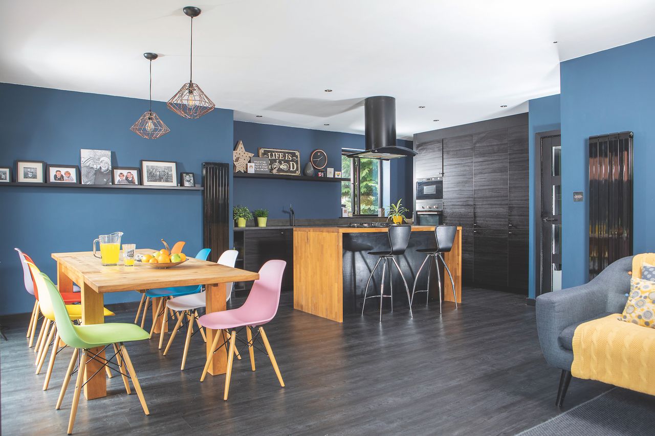 black and blue kitchen diner with wooden worktop