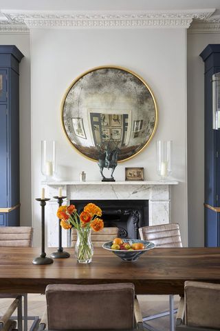 Dining room with round mirror