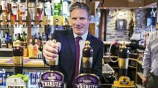 Keir Starmer pulling a pint in a pub while campaigning in 2020