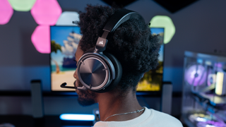 Person playing a video game and wearing a Corsair headset