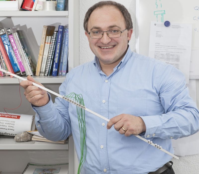 Andrea Bergamini, of Swiss Federal Laboratories for Materials Science and Technology, holds a model of an adaptable phononic crystal that could lead to much quieter consumer appliances.