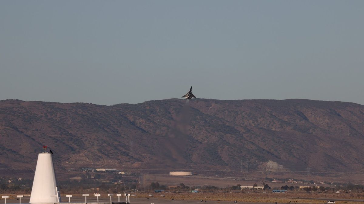 an elongated blue-and-white jet in flight