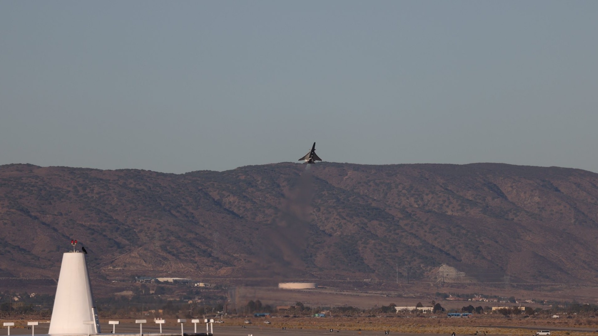 an elongated blue-and-white jet in flight