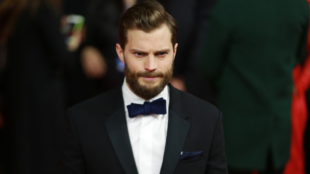 Jamie Dornan with beard, wearing a tux and bowtie