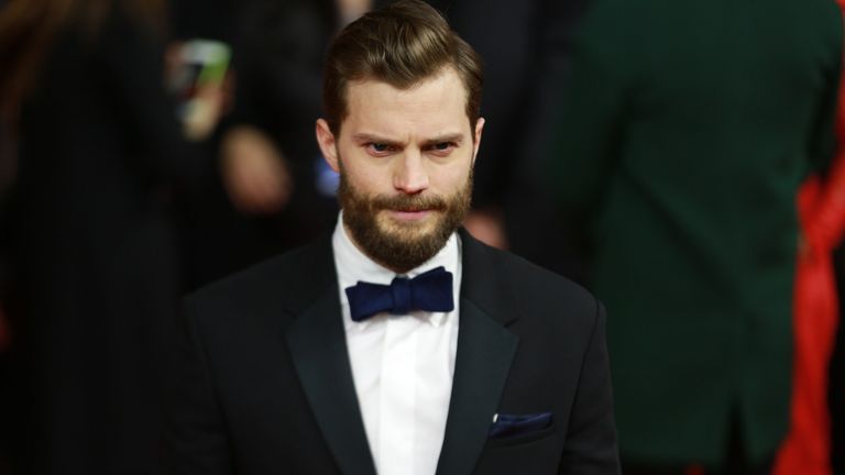 Jamie Dornan with beard, wearing a tux and bowtie