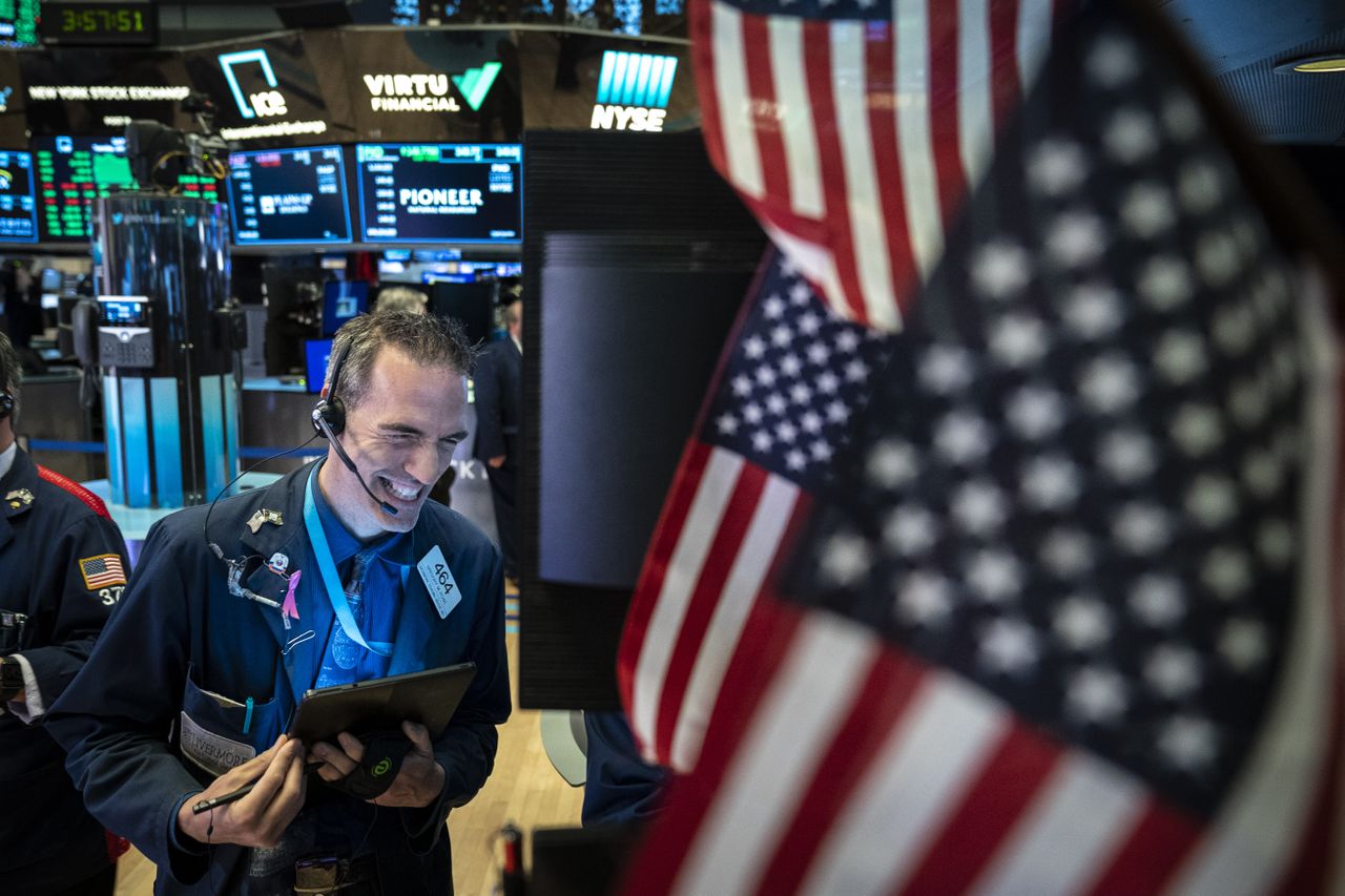 A trader smiles on the NYSE floor