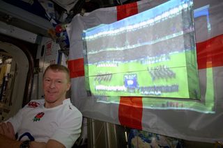 British astronaut Tim Peake of the European Space Agency poses with a broadcast of a 2016 Six Nations Championship rugby match on the International Space Station on Saturday, Feb. 6.