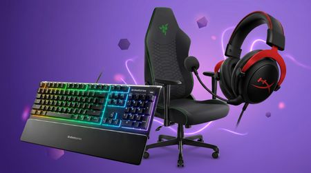 A gaming chair, keyboard and pair of headphones on a purple background
