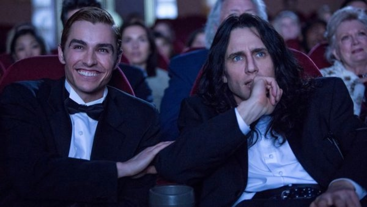 James and Dave Franco sitting together in a movie theater in The Disaster Artist.