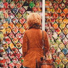 The back of a woman looking at walls of seeds for sale