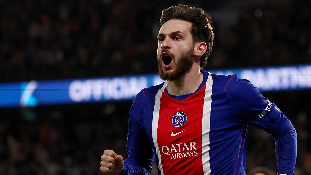 Khvicha Kvaratskhelia, wearing red and and blue of PSG, celebrates scoring a goal in Ligue 1