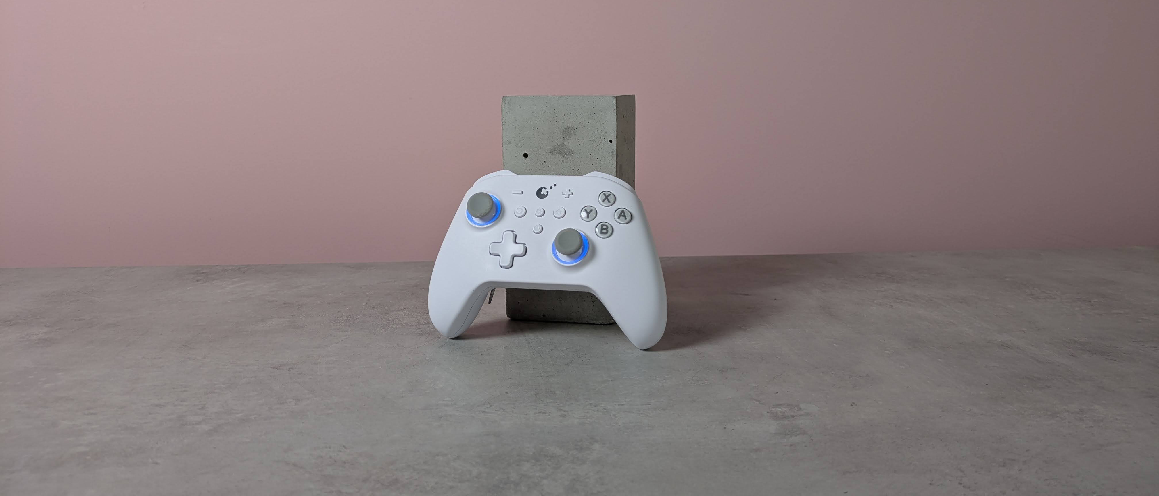 Gulikit KK3 Max leaning on plinth on desk with pink wall in background