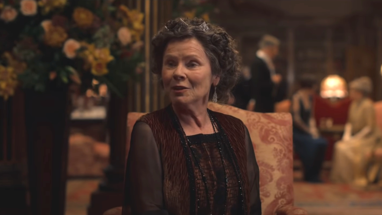 Imelda Staunton sits in discussion in a drawing room in Downton Abbey: The Motion Picture.