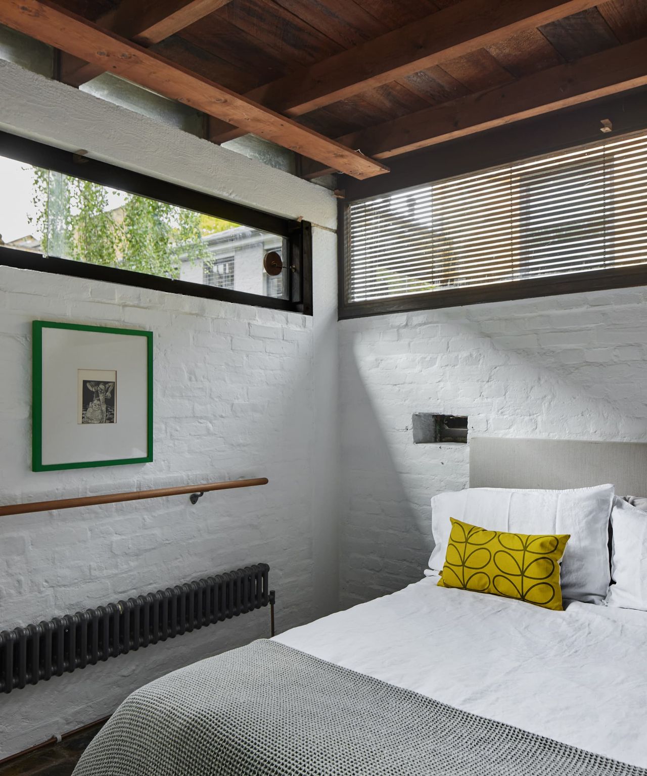 A bed with a small mail hole next to the bed