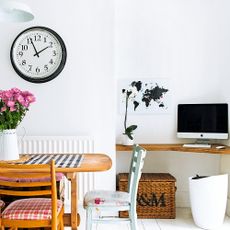 room with white walls and wooden table and chair