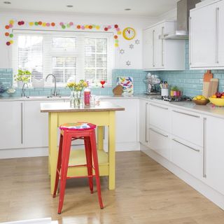 colourful kitchen with painted island and red bar stool