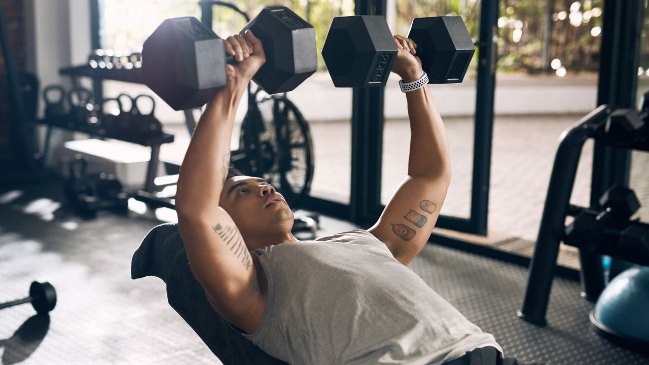 A man performing incline dumbbell chest press