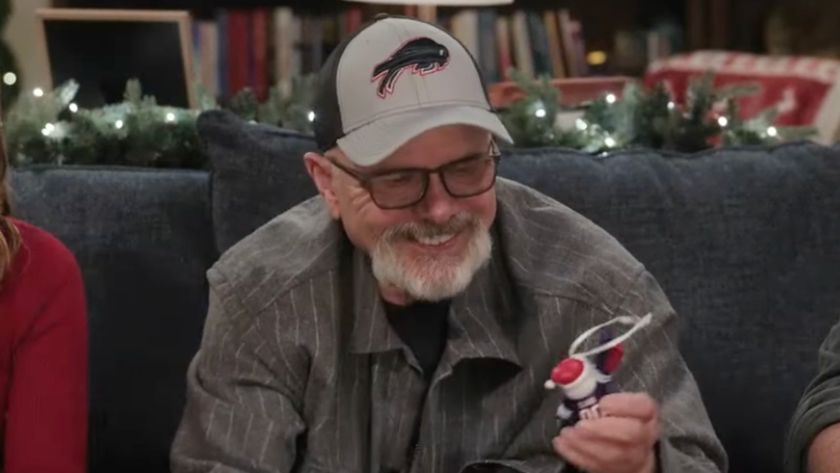 Man in a Bills cap holding an ornament